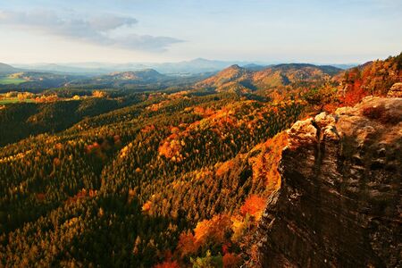 Autumn sunset view over colorful rocks to fall valley of Bohemian Switzerland.の写真素材