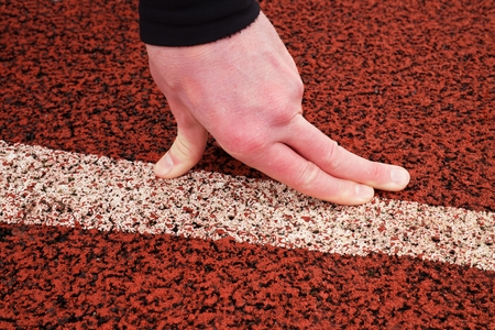 Bended fingers on start line, detailed  red rubber retrack