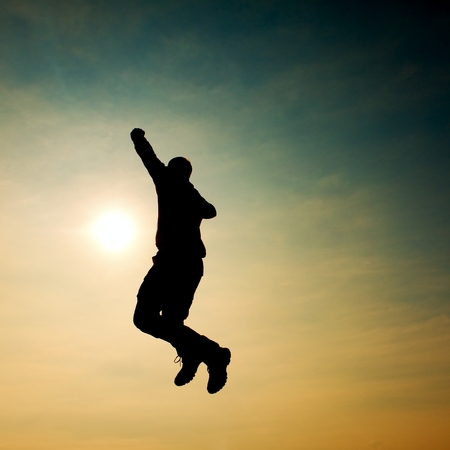 Flying man. Young man falling down on colorful sky background.