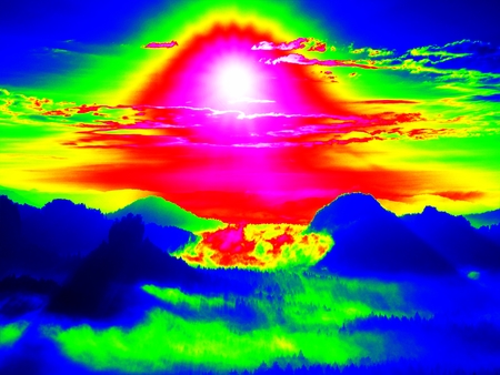 Infrared scan of rocky landscape, pine forest with colorful fog, hot sunny sky above. Grunge background in amazing thermography colors.の写真素材