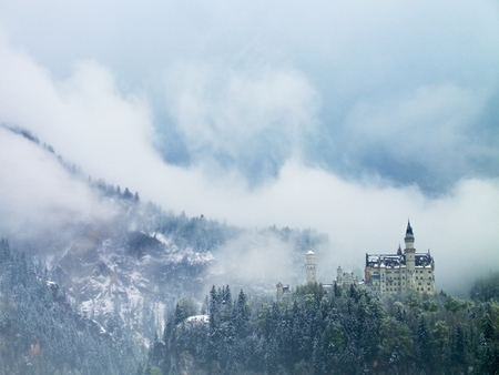 Old castle in mountais, rocks and forest covered with fresh snow and hoarfrost, winter with snow return in spring mountains.の素材 [FY31059061795]