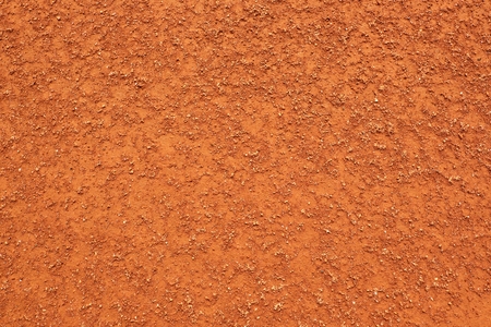 Dry light red crushed bricks surface on outdoor tennis ground. Detail of rough textureの写真素材
