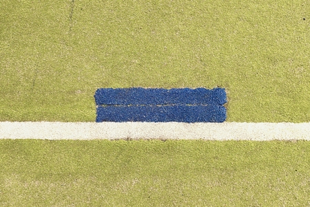 Colorful lines in empty outdoor handball playground, plastic light green surface on ground and white, red and blue lines bounds.の写真素材