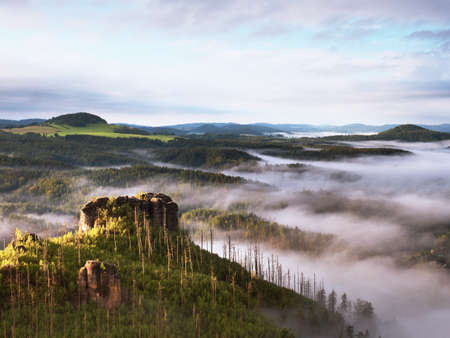 Spring misty landscape. Morning in beautiful hills of natural park. Rocky peaks Increased from...