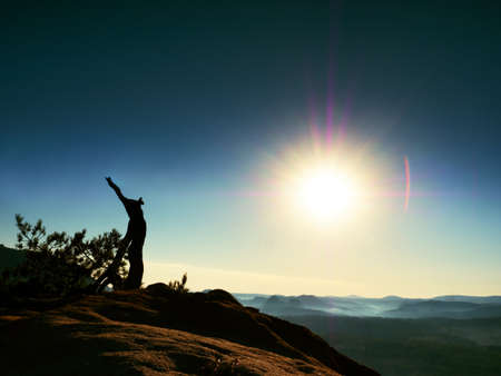 Autumn daybreak in sandstone rocks,broken pine tree.  Fall valley of Saxony Switzerland. Sandstone peaks and hills increased from colorful background.の写真素材