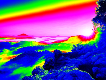 Ultraviolet  scan. Infrared  photo. Freeze autumnal daybreak, rocks covered with fresh powder snow. Stony rock peak increased from fogの写真素材