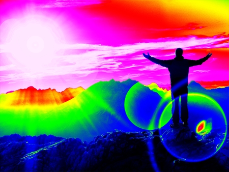 Ultraviolet  scan. Infrared  photo. Young man in black sportswear on cliff edge and looking to misty valley bellow. Autumn cold weatherの写真素材