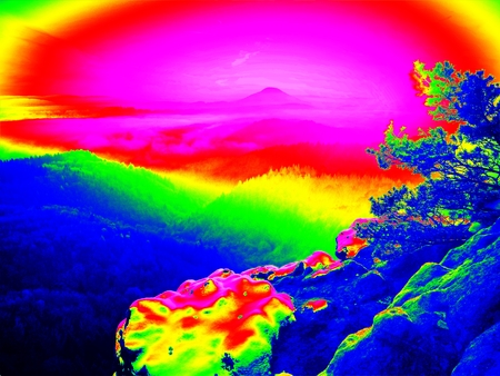 Ultraviolet  scan. Infrared  photo. Freeze autumnal daybreak, rocks covered with fresh powder snow. Stony rock peak increased from fogの写真素材