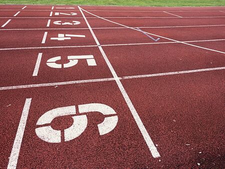 Start. Red running racetrack on the outdoor athletic stadium. Number one,  number two, three, four,...