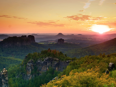 Sunset above sharp sandstone cliffs above deep valley. Popular climbers resort. Deep cracks in rocks donne by strong rain erosionの写真素材