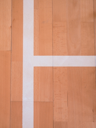 White line in sports hall playground. Renewal  wooden floor of sports hall with colorful marking lines and new lacquered surfaceの写真素材
