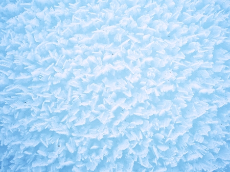 Stucture of crystal snow surface from very close distance. Frozen snow flakes stick together into...