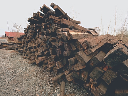 Extracted old wooden ties in stock. Old oiled used oak railway sleepers stored after big reconstruction of old railway station.の写真素材