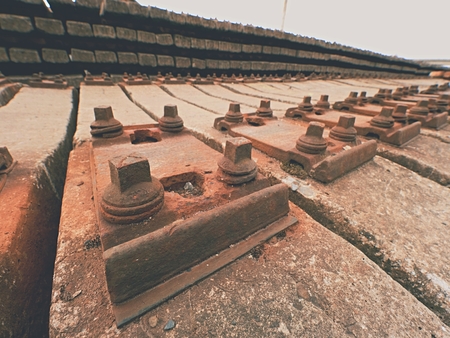 Used sleepers stock in railway depot. Old, dirty and rusty used concrete railway ties stored after big reconstruction of old railway station.の写真素材