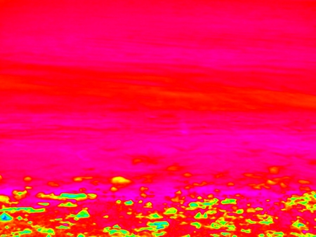 Thermography measurement, changed colors of ultra violet light. Stony ocean beach with big boulders. Thermography effect.の写真素材