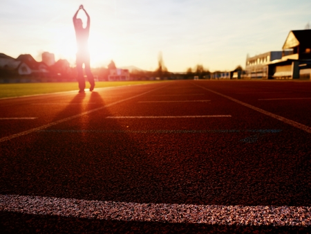 Personal power. Adult man in evening training at sunset. Sport and healthy lifestyle concept, man jogging in civic training workout centreの写真素材