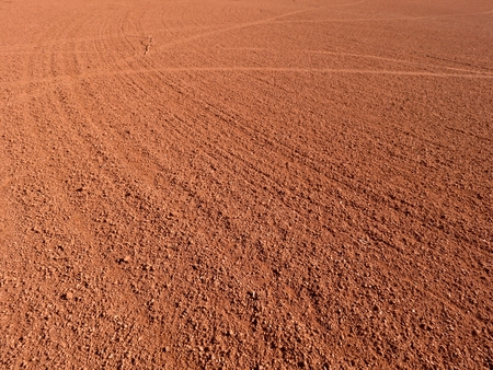 Dry light red crushed bricks surface on outdoor playground tennis courtの写真素材