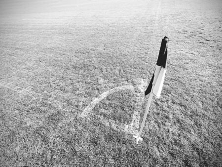 White blue flag in corner of football playground, lazy wind blowingの写真素材