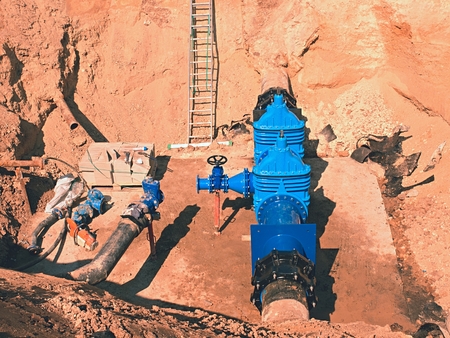 Drink Water Factory. Various pipelines, valve gates and metal pipes. Toned image. Repairing of...