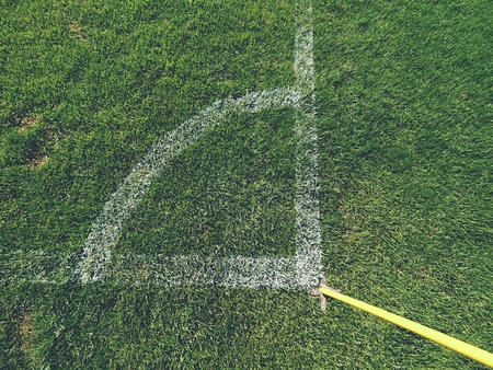 Football field corner detail with white marks and flag stickの写真素材
