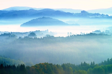 Autumn fog and clouds above freeze  mountain valley, hilly landscape