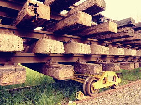 Recycling company stock. Rail platform with old concrete and wooden sleepers extracted  with rail rods waiting for transport to steel foundry for remeltingの写真素材
