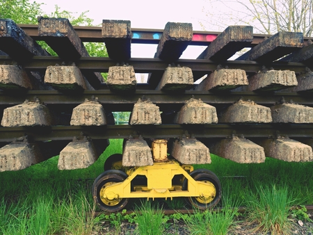 Recycling company stock. Rail platform with old concrete and wooden sleepers extracted  with rail rods waiting for transport to steel foundry for remeltingの写真素材