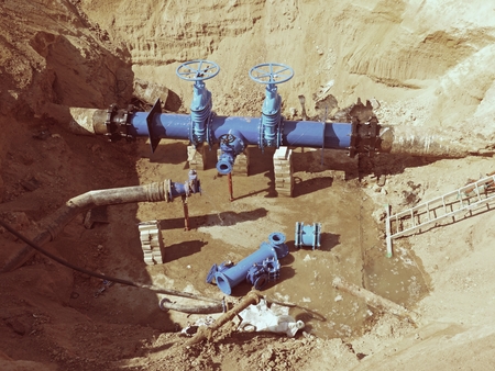 Drink Water Factory. Renewal underground pipelines, valve gates and metal pipes. Toned image....
