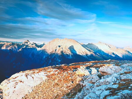 Sharp Alps peaks, rocks without people. View over Alpine rocks above the deep vals to the far horizon. Sunny day with clear blue skyの写真素材