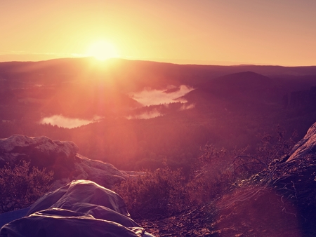 Sleeping in nature in sleeping bag. Beautiful awakening in rocks. View from the rocky peak over the forest valley.の写真素材