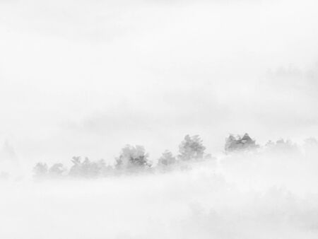 Low poly design. Misty awakening in a beautiful hills. Peaks of hills are sticking out from fogの写真素材