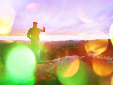 Lens defect. Amateur takes photos with smart phone on peak of rock. Dreamy fogy landscape, spring...