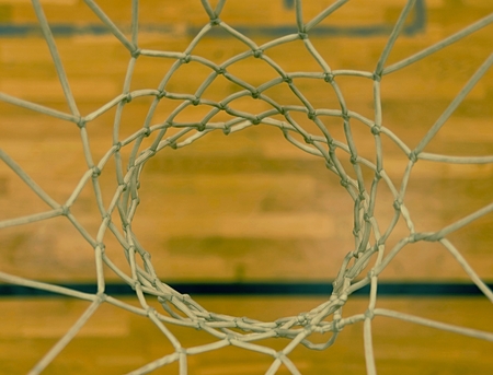View through basketball hoop. Looking to floor through white net from up to down. の写真素材