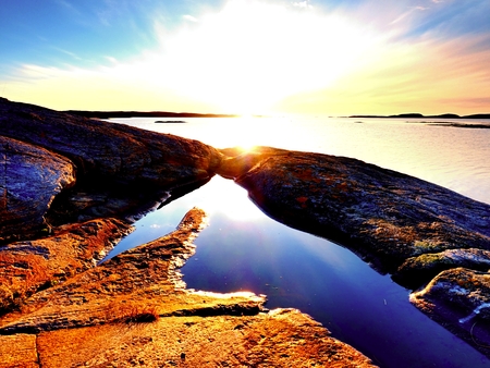 Mysteries of dawn. Sea sunrise above the Sea coast, silent water level. Clear blue sky in holiday resortの写真素材