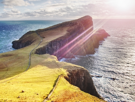 Famous look at Lighthouse on the cliff of Neist Point, rugged and rocky coast on the western side Isle of Skye, Scotland, United Kingdom, Europeの写真素材