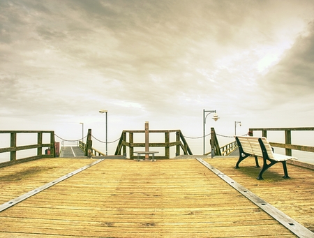 Wooden pier in summer holiday destination. Late summer landscape with cloudy sky.  Baltic sea coast Germany travel destinationの写真素材