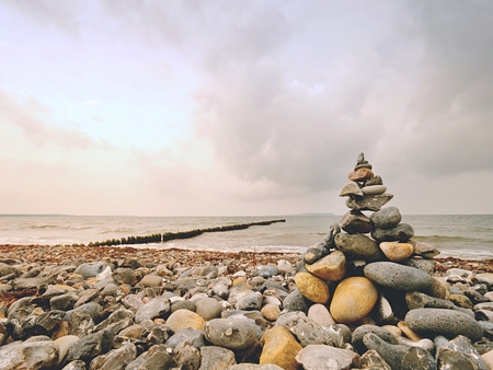 Stacked rounded stones on the stony beach in summerの写真素材