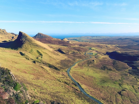 Winter colors of hilly landscape on the Isle of Skye in Scotland. Beautiful Quiraing range of mountains within sunny February dayの写真素材
