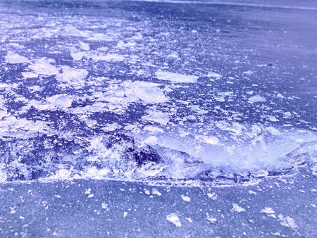 Arctic ice. A large piece of natural ice on a green blue flat ice of frozen lake, water bubbles...