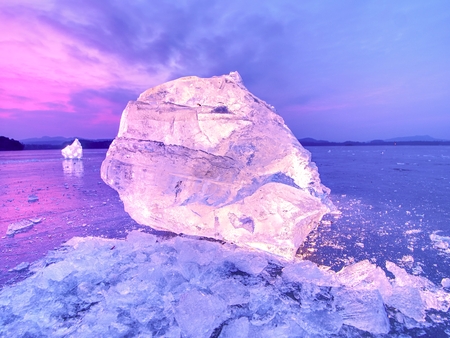 Cut ice. Crushed cubes lighted with strong backlight.  Silent bay  with flat frozen level.  The light spectre in ice.の写真素材