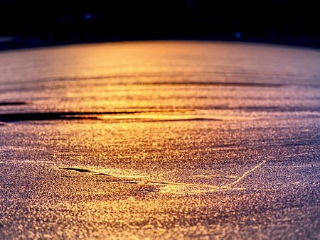 Ice shard and small cracked ice pieces on melring glacier. Icy fragments are melting on flow ice and dark laggon waterの写真素材
