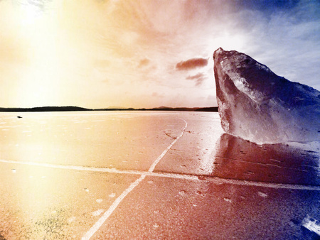 Abstract effect.  Ice floe and crushed ice on dark frozen and flat  ground. Shining crushed ice in...
