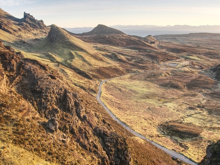 Spring view of Quiraing mountains with blue sky, Isle of Skye. Sharp rocky mountains above vallley....
