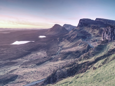 Spring view of Quiraing mountains with blue sky, Isle of Skye. Sharp rocky mountains above vallley. Sunny winter midday.の写真素材