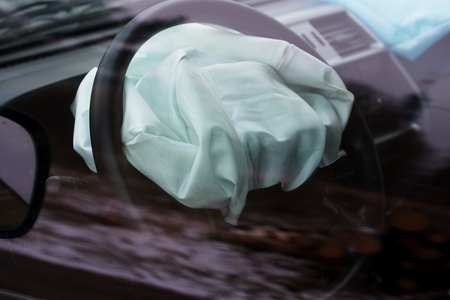 Airbag exploded at car accident. Car crash and airbag worked well. View through closed windowの写真素材