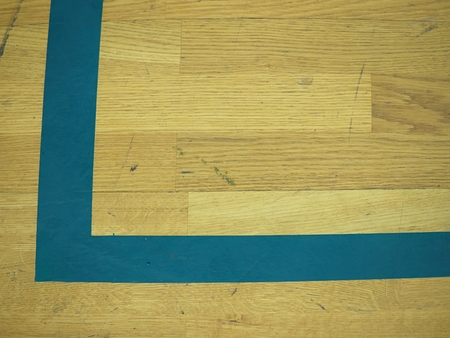 Gym wood floor with playground lines, parquet hardwood in school court. The floor viewed from above for texture patternの写真素材