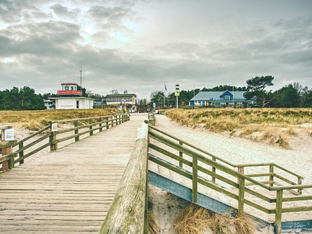 Wooden batten bridge juts out into the expanse of the sea. The famous tourist attraction for romantic soulsの写真素材