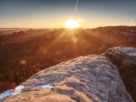 Morning view over sandstone formation into misty valley. Fantastic dreamy sunrise on top of rocky mountainの写真素材