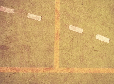 Border lines on court. Worn out green red hairy carpet on outside hanball playground. Jogging area  outdoor stadium with a tartan track.の写真素材