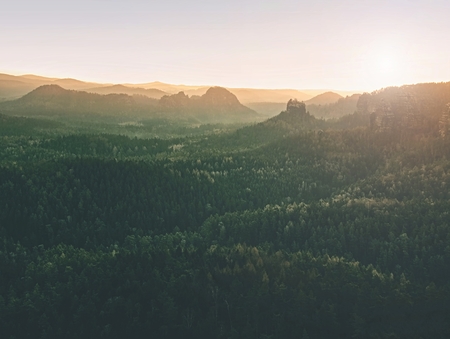 Beautiful misty sunrise in toned picture . Autumn hilly landscape covered with shinning fog.  Sharp...